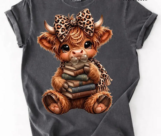 Highland cow with books brandedbybarta